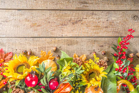 Festive autumn background, still life decor with pumpkins, berries, leaves on wooden background....