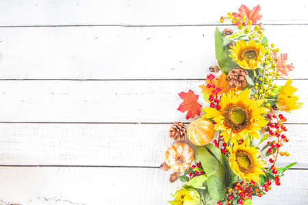 Festive autumn background, still life decor with pumpkins, berries, leaves on white wooden background. Concept background for Thanksgiving or Halloween holiday, copy space, flatlayの写真素材