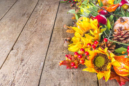 Festive autumn background, still life decor with pumpkins, berries, leaves on wooden background. Concept background for Thanksgiving or Halloween holiday, copy space, flatlayの写真素材