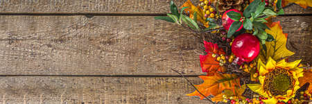 Festive autumn background, still life decor with pumpkins, berries, leaves on wooden background....