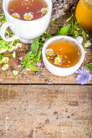 Different herbal tea set. Various cups with organic herbal, flower tea - camomile, chicory, melissa mint, lavender. Organic natural drinks concept. Health and immunity care beveragesの写真素材