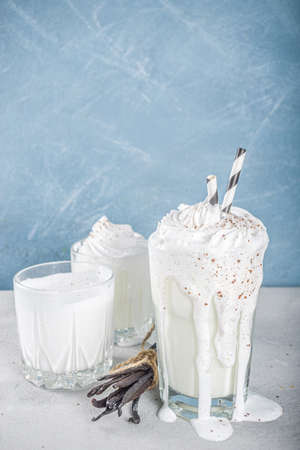 Vanilla bean milkshake. Glass with cold Vanilla milkshake with Vanilla beans, copy spaceの写真素材