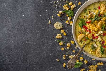 Homemade autumn classic corn cream soup with grilled corn, herbs and croutons, copy spaceの写真素材