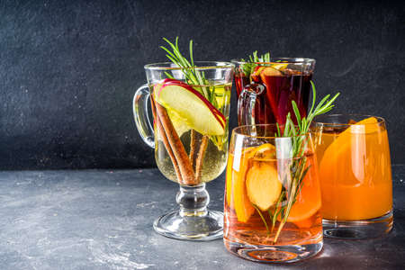 Various autumn winter alcohol drinks set. Different seasonal alcohol cocktails - mulled wine, glogg, grog, eggnog, ginger ale, hot buttered rum, punch, apple cider, sangria, white backgroundの写真素材