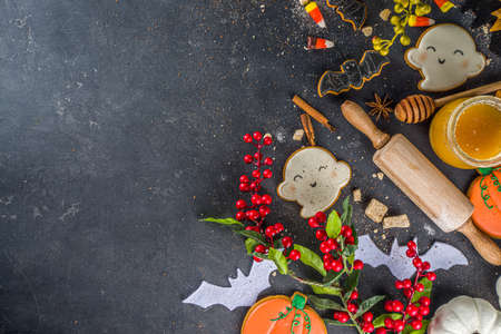 Halloween baking background with baking utensils and Halloween styled Gingerbread Cookies, black...