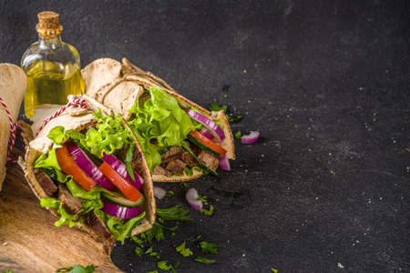 Turkish kebab wrap shawarma sandwiches. Tasty fresh wrap sandwiches with beef meat and vegetables, Traditional Middle Eastern snack.の写真素材