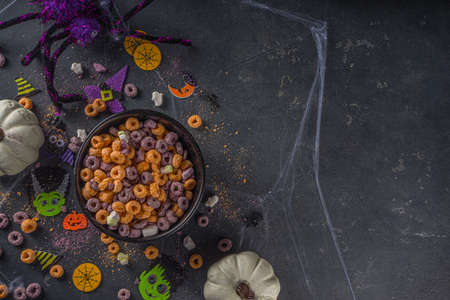 Funny kids cereal breakfast for halloween. Purple and orange breakfast cereal flakes with pumpkin...