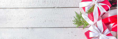 Merry Christmas and Happy New Year. Noel greeting card background. Christmas gift boxes with festive ribbons, flatlay top view copy space, bannerの写真素材