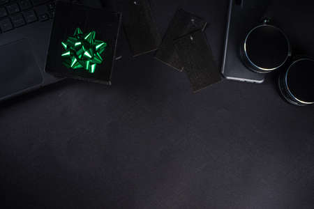 Christmas Clearance and Sale Concept. Black Friday, Green Monday (Cyber Monday) Sale. With Discount Price Tags, Black gadgets and accessories, Shopping Bag. Flat lay top view, black matte backgroundの写真素材