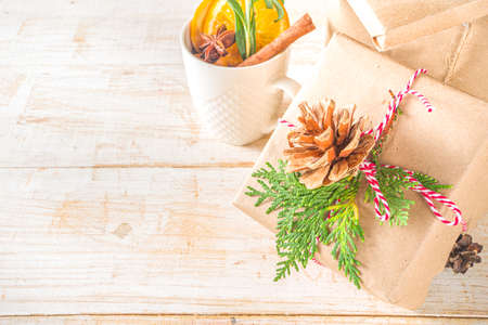 Christmas Background with Gift Boxes Wrapped in Craft Paper on white table. Preparation for...