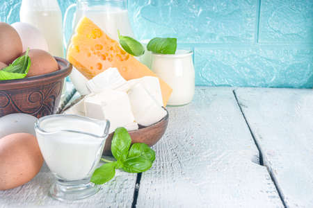 Set of Various Fresh Dairy Products - milk, cottage cheese, cheese, eggs, yogurt, sour cream, butter on wooden backgroundの写真素材