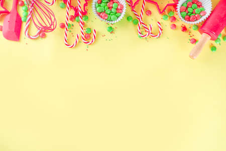 Christmas Baking Utensils and ingredients. Confectioner or Baker Workplace, with Utensils and accessories for making festive Christmas sweet cookies, cakes. Bright yellow background copy space aboveの写真素材