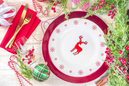 Christmas or New Year table setting. Place setting for Christmas Dinner. On wooden background with...