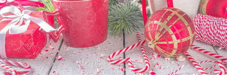 Festive composition with fir tree branches, Christmas decor and baubles, gift box with festive...