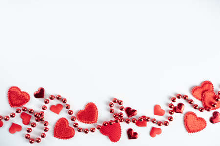 Saint Valentine's day greeting card, border of holiday symbols, on white background. Various red...