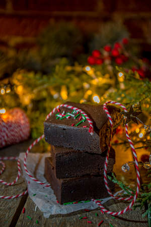 Christmas brownie cake pieces, dark chocolate sweet dessert on wooden background with Xmas decoration,の写真素材