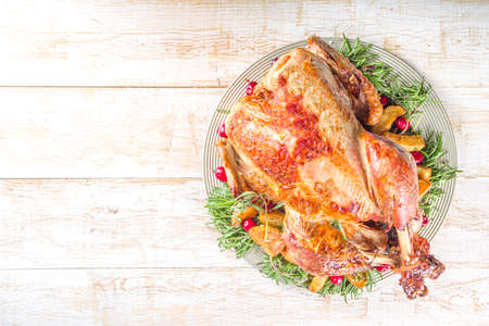 Christmas or New Year turkey dinner. Baked turkey with potato, red berries and sage leaves, on...