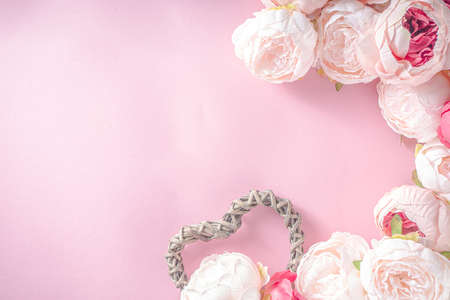 Valentine day background with Tender Pink Red White Peony Flowers and Heart Shaped Valentine Day Decor, Pink Background copy spaceの写真素材