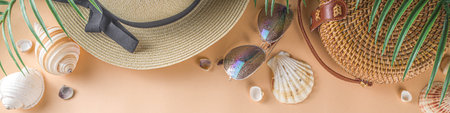 Trendy summer flat-lay with female fashion outfit - straw hat, bamboo bag, sunglasses, on peach...