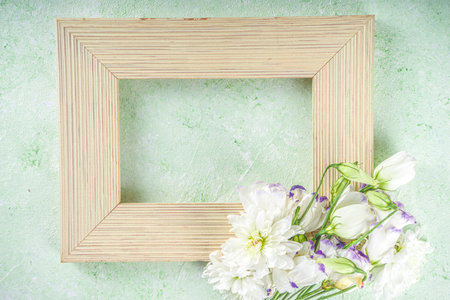 Springtime holidays background. Bouquet of garden spring flowers on pastel green table top view....