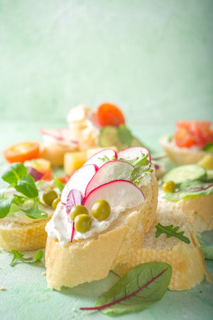Spring diet healthy food background. Breakfast sandwich with baguette toast bread with cream cheese,...