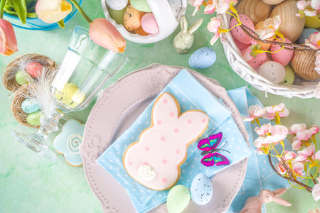Festive Easter table setting with traditional spring flowers, Easter colorful eggs and sugar...