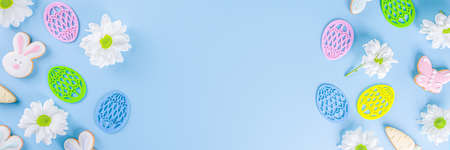 Easter poster background with Easter eggs in nests on light blue background. Greetings card,...