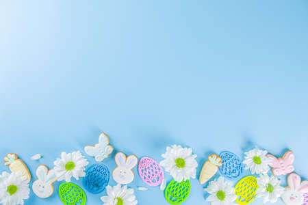 Easter poster background with Easter eggs in nests on light blue background. Greetings card,...