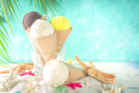 Summer tropical sea holiday vacation concept. three ice cream waffle cones with different flavors of...