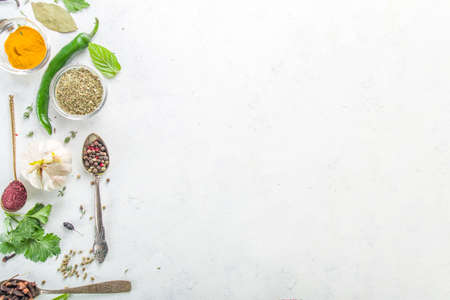 Fresh herbs, dried colorful spices. Cooking background flatlay with variety spices, herbs pepper,...