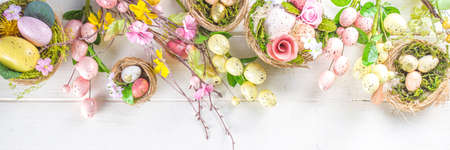 Happy easter background with Nests decoration, colorful eggs and Spring Flowers. Caster card on...