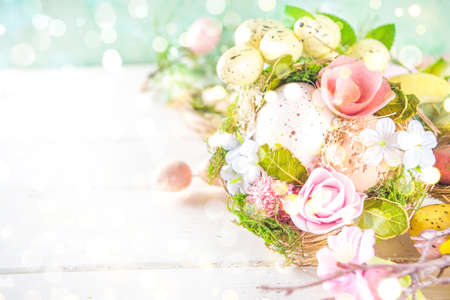 Happy easter background with Nests decoration, colorful eggs and Spring Flowers. Caster card on sunny spring backgroundの写真素材