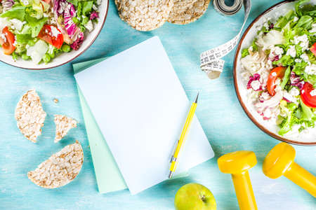 Healthy eating, slimming. dieting and weigh loss concept background. Fresh greenery summer salad...