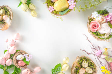 Easter greeting card background. Spring tree decor branches with colorful eggs, flowers and leaves...