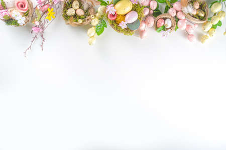 Easter greeting card background. Spring tree decor branches with colorful eggs, flowers and leaves...