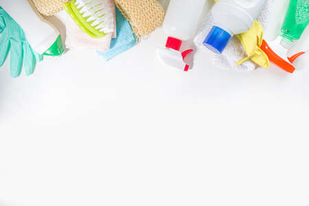 Spring cleaning background. Spring cleaning tools, utensils, accessories background, flatlay with hard light and dark shadows. On white background copy spaceの写真素材