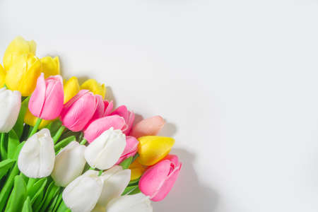 Colorful Tulip Flower Bouquet on white table background top view copy space for text