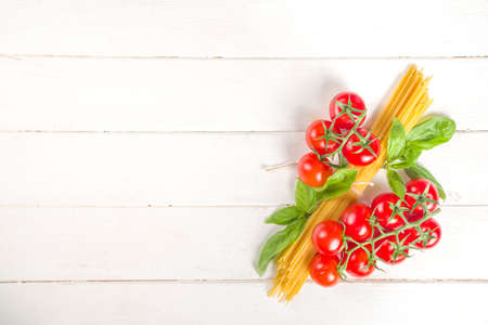 Mediterranean food, italian pasta spaghetti cooking ingredients, on white wood kitchen table background top view copy space for textの写真素材