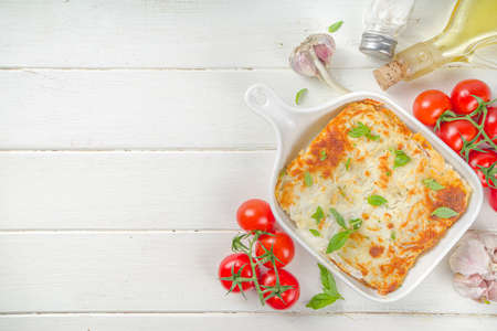 Mediterranean food, Italian traditional lasagna pasta, with bolognese, bechamel and cheese. On white kitchen table backgroundの写真素材