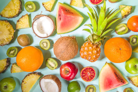Summer vitamin food concept, various fruit and berries background - watermelon pineapple apples kiwi...
