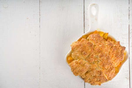 Delicious Summer Peach Cobbler, Homemade sweet summer pie with peaches and vanilla ice cream on...