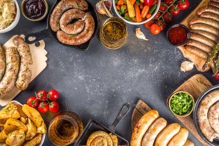 Assortment of different fried sausages. Set with various meat Bavarian, Frankfurt, German grilled sausages, Oktoberfest or summer BBQ party concept, bkack concrete background copy space top viewの素材 [FY310167158112]