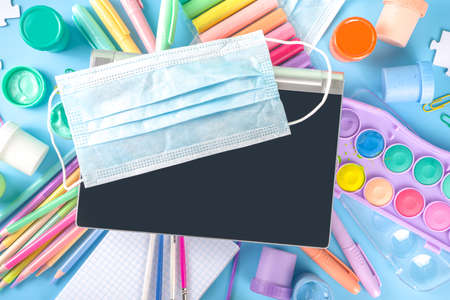 Online study and drawing, distantly painting class. Various colorful stationery and supplies for drawing. paints, pastels, pencils, brushes, tablet on blue background. Flatlay top view copy spaceの写真素材