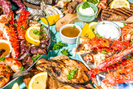 Assortment various barbecue Mediterranean grill food - fish, octopus, shrimp, crab, seafood, mussels, summer diet bbq party fest, with kebab, sauces, light blue sunne wooden backgroundの写真素材