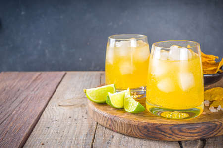 Summer boozy citrus cocktail, citrus margarita, tequila drink with salt and Mexican chips, Summer cold cocktail concept, copy spaceの写真素材