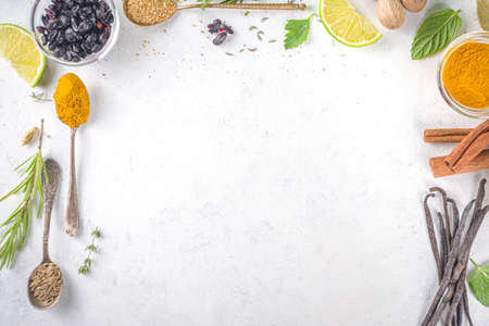 Fresh herbs, dried colorful spices. Cooking background flatlay with variety spices, herbs pepper,...