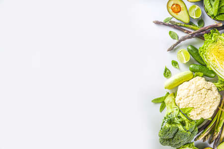 Healthy Diet Spring food background. Assortment of fresh raw organic green vegetables - broccoli,...