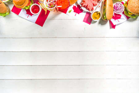 Set of various Canada Day bbq food. Picnic party table with maple leaf shaped watermelon, flags,...