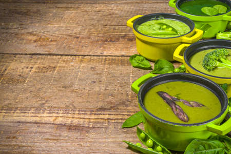 Green cream-soup set. Variety of classic green vegetable soups, in small portioned potsの写真素材