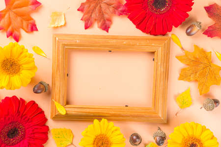 Autumn Seasonal Flowers and Decor Background. Warm beige table with pumpkins, red, yellow and orange...